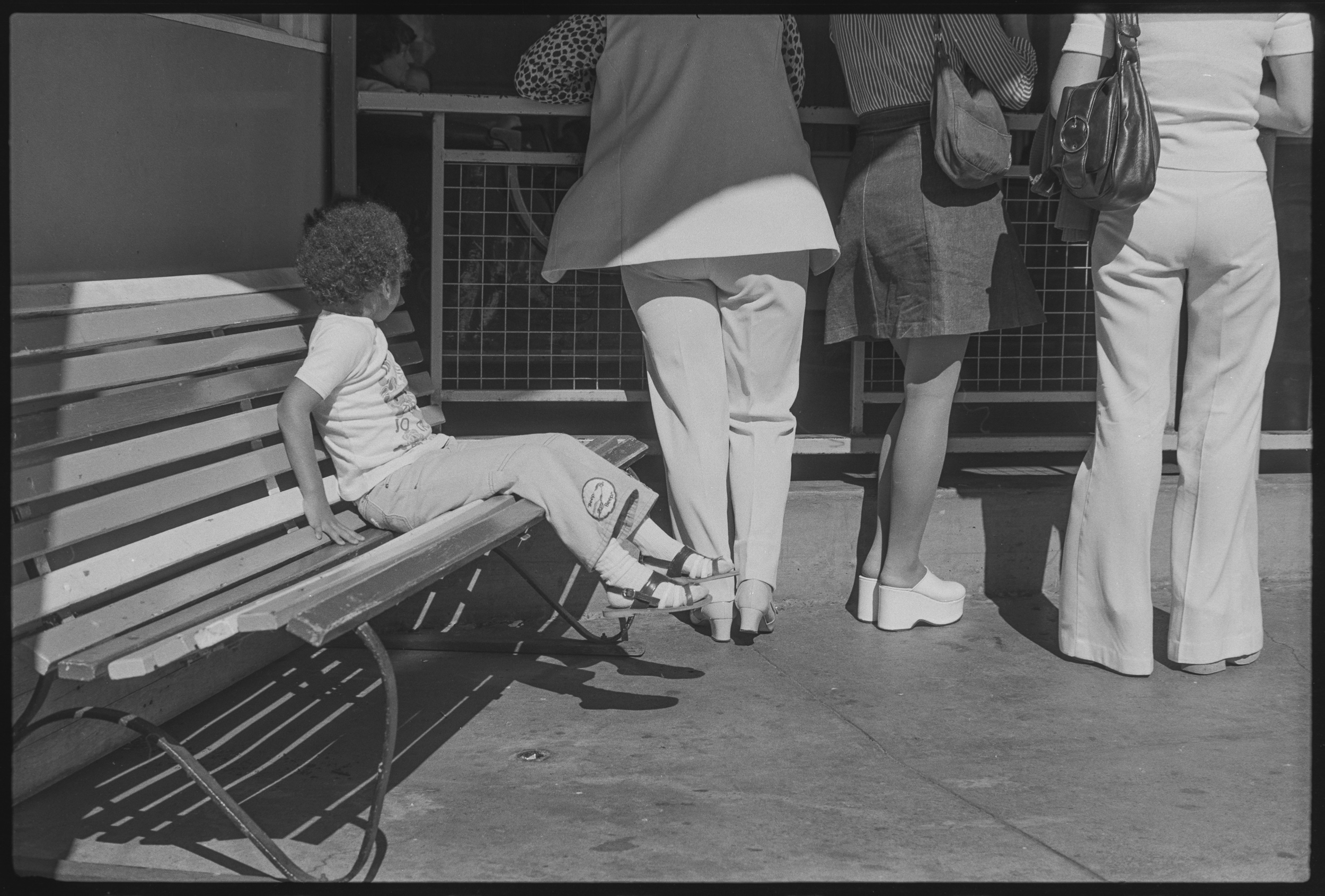 1975 36 75 39 St Kilda Luna Park. Young Child waiting for family members/friends to return with tickets or after their ride has finished ScanNo026 Julie Millowick MINOLTA SRT 101